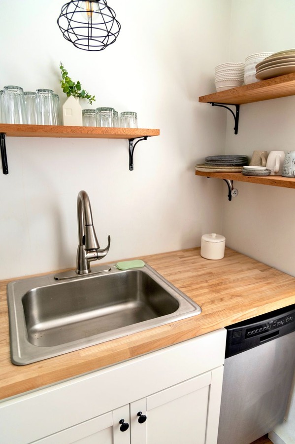 Before: kitchen with open shelving and visual disorder